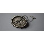 A Victorian White Metal Oval Brooch with Pierced Chinese Style Decoration Depicting Storks