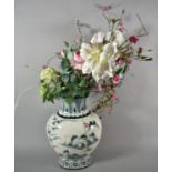 A Large Blue and White Vase Containing Artificial Flowers, 40cm high