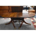 A Reproduction Mahogany Twin Pedestal Table with One Extra Leaf, Brass Claw Casters, 109cm wide