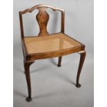 An Edwardian Cane Seated Nursing Chair with Vase Splat