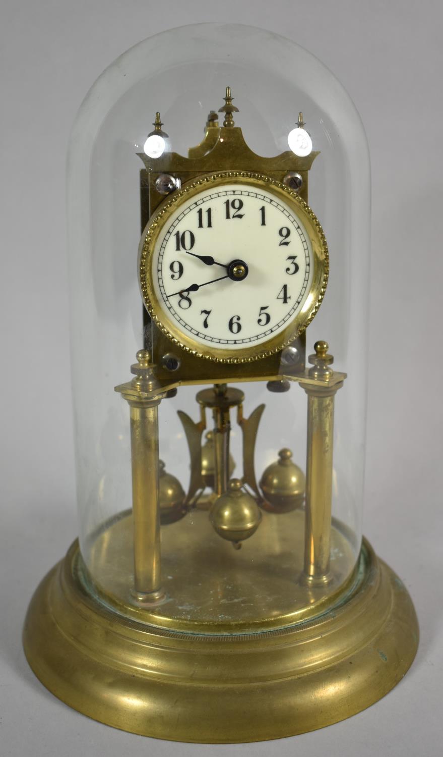 An Edwardian Brass Pillar Clock Under Glass Dome, 28cm high