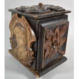 A Continental Carved and Stained Black Forest Box Decorated with Panels Depicting Leaves, Birds,