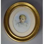 A Gilt Framed Oval Portrait of a Young Boy