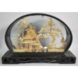An Oriental Cased Intricately Carved Cork wood Diorama Depicting Storks, Trees and Pagoda, Plinth