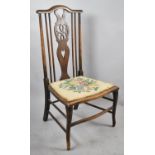 An Edwardian Tapestry Seated Ladies NUrsing Chair with Pierced Wheel Back