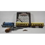 An O Gauge Clockwork Locomotive and Two Carriages Together with a Toy Revolver and Sudoku Game