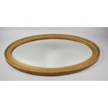 A Gilt Framed Oval Wall Mirror with Bevelled Glass, 77.5cm high