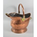 A Copper Helmet Shaped Coal Scuttle Together with a Brass Wooden Handled Scoop