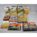 A Collection of Jurassic Dinosaur Toys and Three Jigsaw Puzzles