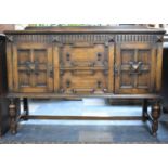 An Edwardian Oak Galleried Sideboard with Two Fielded Centre Drawers Flanked by Panelled Doors to