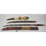 Two Tribal Daggers in Leather and Animal Skin Sheaths Having Woven Decoration, Leather Handles