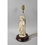 A Modern Figural Table Lamp in the Form of Girl with Bonnet and Posy of Flowers