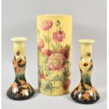A Pair of Ceramic Candle Sticks and Cylindrical Floral Decorated Vase, 30.5cm high