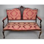 An Edwardian Mahogany Framed Serpentine Front Saloon Armchair, One Leg Detached but is Present,