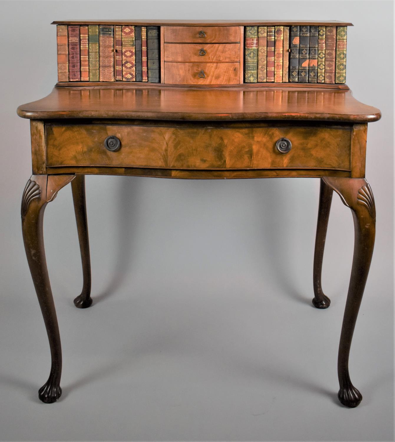 A Reproduction Walnut Carlton House Style Writing Desk with Serpentine Fronts and Raised Back Having