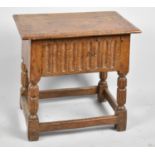 A Oak Peg Jointed Box Stool with Carved Front Panel and Turned Reeded Supports, Hinged Lid, 47.5cm