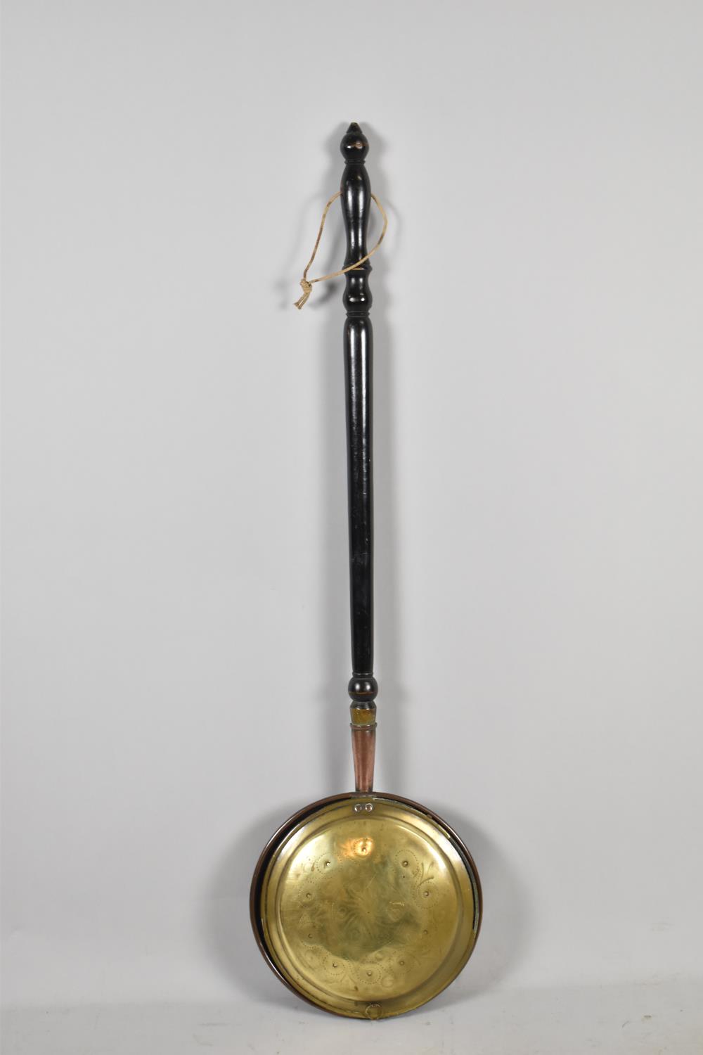 A Brass Bed Warming Pan with Turned Ebonised Handle