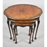 A Mid 20th Century Burr Walnut Nest of Three Oval Tables, the Largest 60cm Wide