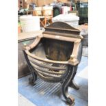 A Reproduction Cast Metal Bow Fronted Regency Style Fire Basket with Scrolled Support and Brass