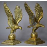A Pair of Large Brass Studies of Eagles with Wings Outstretched and Standing on Globes, 30cm high