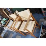 A Set of Four Folding Canvas Seated Directors Chairs