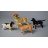 A Collection Three Beswick and One Other Dog Ornaments