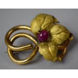 A Victorian Yellow Metal Tube Brooch with Later Yellow Metal Leaf Mount Housing a Large Ruby