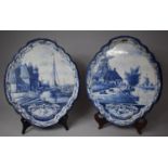 A Pair of Blue and White Dutch Delft Wall Plaques of Oval Form Depicting Windmills, Canals and