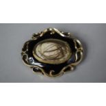 A 9ct Gold Victorian Mourning Brooch with Black Enamel and Containing Human Hair, 29.1g Total