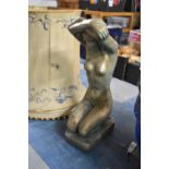 A Cast Gilt Reconstituted Garden Ornament in the Form of a Kneeling Nude Maiden, 50cm High