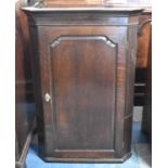 A George III Wall Hanging Corner Cupboard with Shaped Shelves Behind Panelled Door, 103cm High and