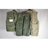 A Collection of Three Fishing Vests One with Enamelled Badges Together with a Wychwood Canvas