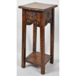 An Edwardian Oak Square Topped Plant Stand with Carved Decoration and Stretcher Shelf, 65cm high