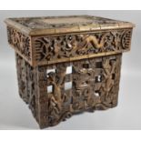 An Interesting Heavily Carved Oriental Folding Box Seat Decorated with Dragons, One Panel Missing