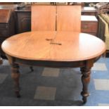 A Late Victorian Oval Wind-out Dining Table with Two Extra Leaves, Turned Supports, Extends to 240cm