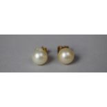 A Pair of Pearl Earrings on Gold Metal Posts