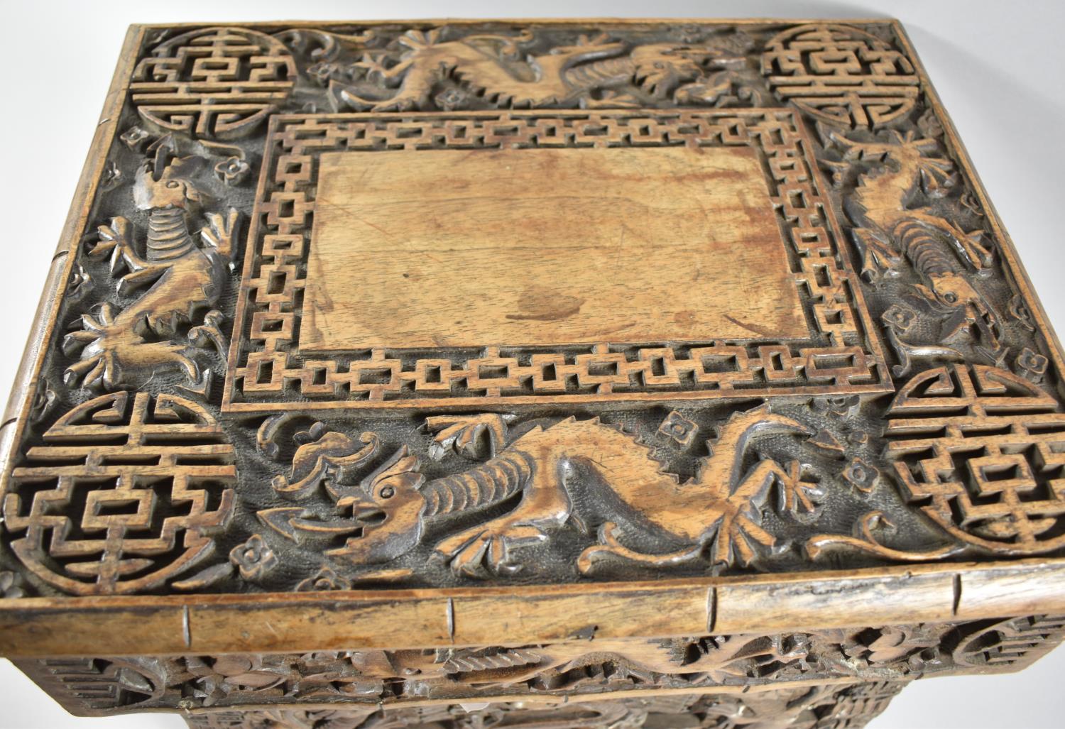 An Interesting Heavily Carved Oriental Folding Box Seat Decorated with Dragons, One Panel Missing - Image 4 of 7