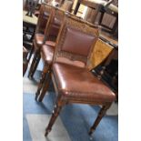 A Set of Three Edwardian Hide Seated Side Chairs with Carved Top Rails and Turned Carrying Handles