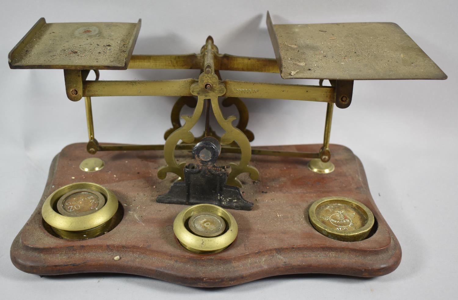 A Set of Early 20th Century Brass Postage Scales on Serpentine Front Wooden Plinth, Some Weights but