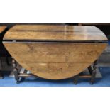 A Late 19th Century Oak Drop Leaf Gate Legged Oval Topped Table, 135cm Long