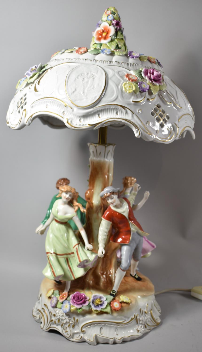 A Modern German Figural Porcelain Table Lamp in the Form of Couples Dancing Around Tree Stump,