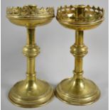 A Brass Candlesticks with Castellated Trays on Circular Bases, 20cm high