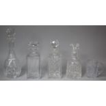 A Collection of Various Cut Glass Decanters and a Glass Tankard