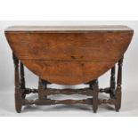 An Early Oak Drop Leaf Gate Leg Table with Oval Plank Top Tuned Supports and Stretchers, 104cm Long
