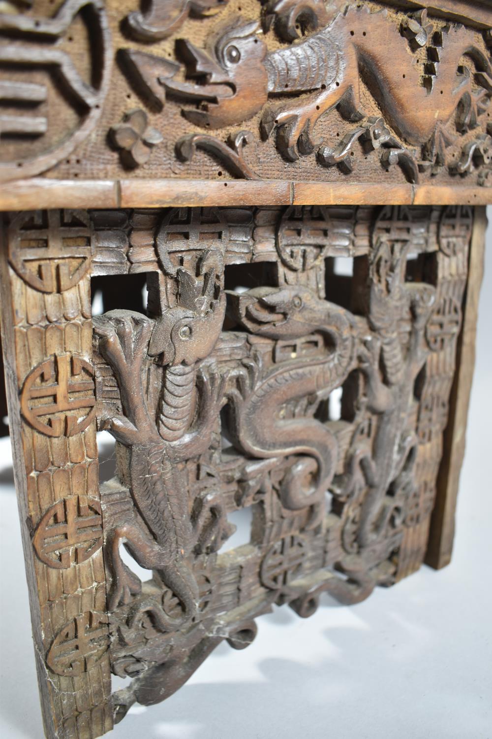 An Interesting Heavily Carved Oriental Folding Box Seat Decorated with Dragons, One Panel Missing - Image 7 of 7