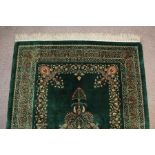 A Stunning Persian emerald green silk Qum carpet