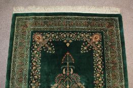 A Stunning Persian emerald green silk Qum carpet