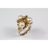 ..A Lady's 14ct Yellow Gold Stylistic Diamond and Pearl Ring