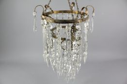 An Elegant Circular Gilt Brass Cut-Crystal Chandelier