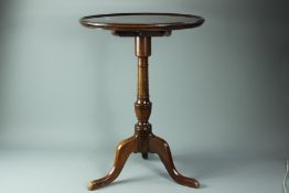 A mahogany circular occasional table